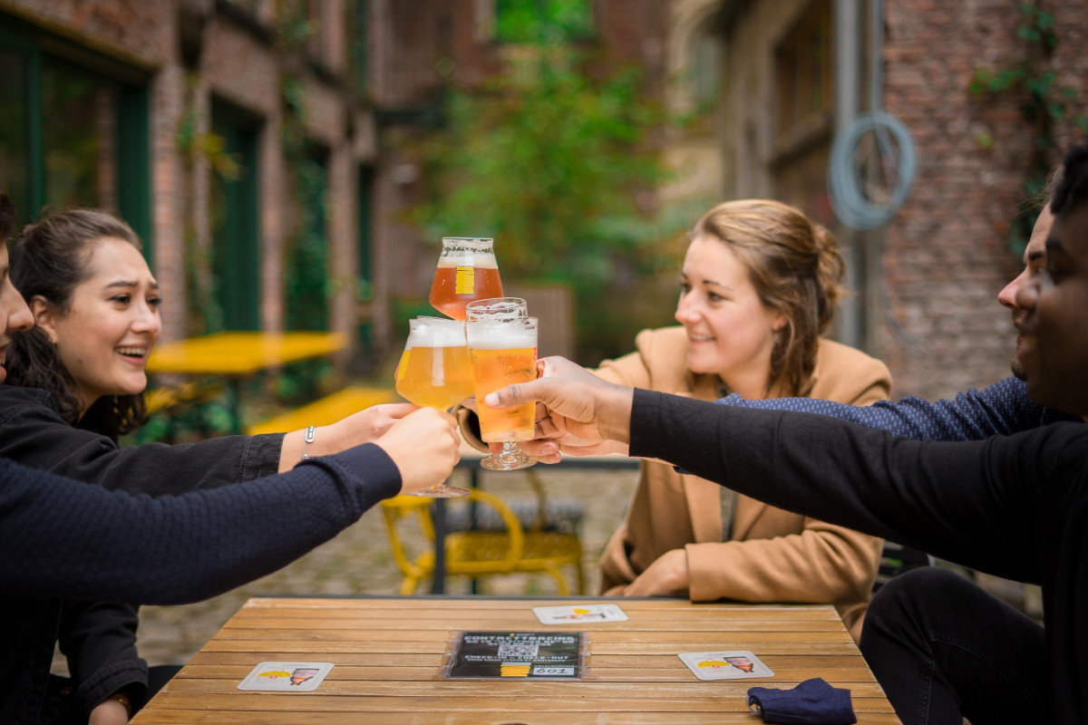 Friends drinking beer on a terrace